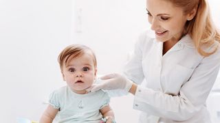 Mumps – Schmerzhafte "Hamsterbacken" Ärztin untersucht ein Kleinkind mit dicker Backe