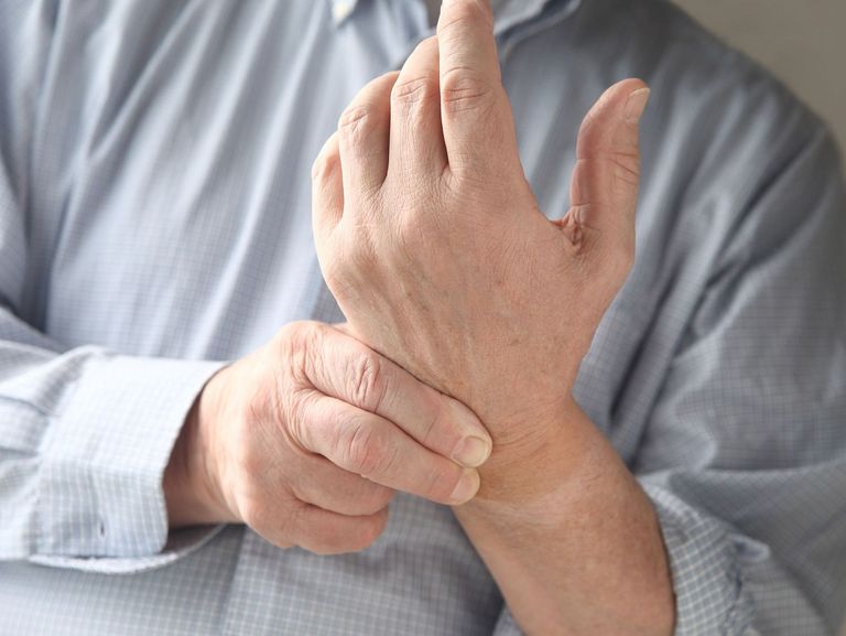 Mann hat in den Handgelenken Schmerzen