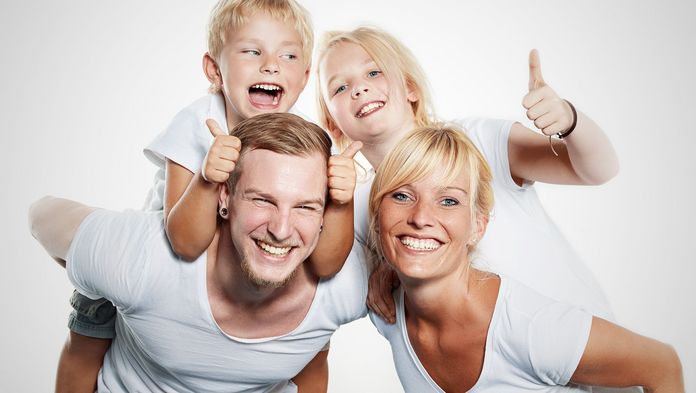 Beitragssätze der IKK gesund plus Vierköpfige Familie lacht in die Kamera
