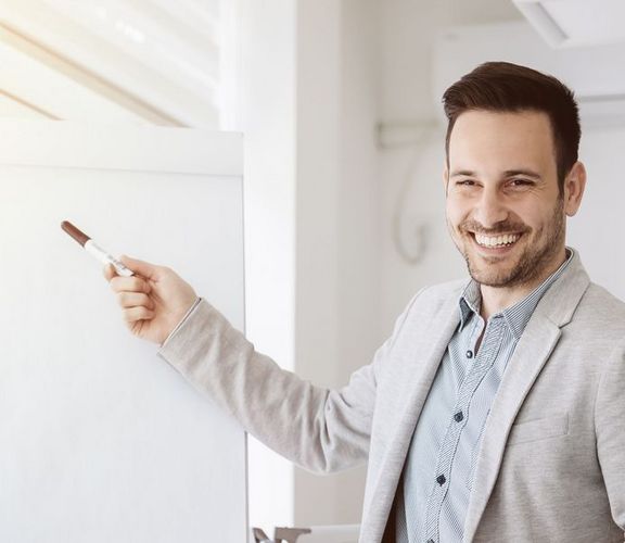 IKK-Jahreswechselseminare Ein Büro-Mitarbeiter präsentiert etwas vor einem Flipchart