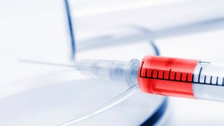 Grippeschutzimpfungen Spritze mit rotem Impfstoff