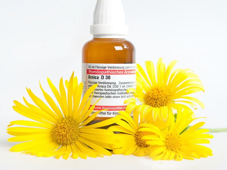 Arnikablüten liegen auf einem Tisch