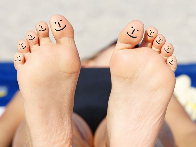 Fußsohlen mit Smileys auf jedem Zeh